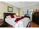 Main bedroom with a dresser and sliding door to lanai at 3185 Charter Club Dr # A, Tarpon Springs, FL 34688