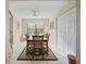 Formal dining room with wood table and access to living room at 3185 Charter Club Dr # A, Tarpon Springs, FL 34688