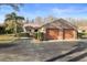 Tan villa with a two-car garage and neatly trimmed hedges at 3185 Charter Club Dr # A, Tarpon Springs, FL 34688