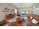 Spacious living room with leather furniture and wood accents at 3185 Charter Club Dr # A, Tarpon Springs, FL 34688