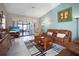 Living room with leather couches and access to lanai at 3185 Charter Club Dr # A, Tarpon Springs, FL 34688
