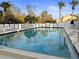 Community swimming pool with lounge chairs at 3185 Charter Club Dr # A, Tarpon Springs, FL 34688