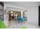 Screened porch with table and chairs, view to living room at 3185 Charter Club Dr # A, Tarpon Springs, FL 34688