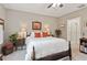 Bright bedroom with a king-size bed and access to a full bathroom at 32857 Brooks Hawk Ln, Wesley Chapel, FL 33543