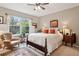 Main bedroom with a king-size bed and an ensuite bathroom at 32857 Brooks Hawk Ln, Wesley Chapel, FL 33543