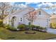 Gray one-story house with landscaped yard, two-car garage, and a manicured lawn at 32857 Brooks Hawk Ln, Wesley Chapel, FL 33543