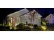 Beautiful home exterior at night with landscaping and lighting at 32857 Brooks Hawk Ln, Wesley Chapel, FL 33543