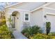 Inviting front entry with a walkway and lush landscaping at 32857 Brooks Hawk Ln, Wesley Chapel, FL 33543