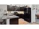 Modern kitchen with dark cabinetry, granite counters, and stainless steel appliances at 32857 Brooks Hawk Ln, Wesley Chapel, FL 33543