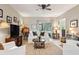 Inviting living room with comfortable seating and large windows at 32857 Brooks Hawk Ln, Wesley Chapel, FL 33543