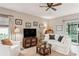 Bright living room features comfy seating, a large TV, and access to a screened patio at 32857 Brooks Hawk Ln, Wesley Chapel, FL 33543