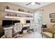 Home office with two workstations, built-in shelving, and a comfortable chair at 32857 Brooks Hawk Ln, Wesley Chapel, FL 33543