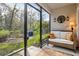 Enjoy the view from this cozy screened porch with outdoor seating at 32857 Brooks Hawk Ln, Wesley Chapel, FL 33543