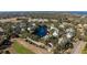 Aerial view of a community near a lake, featuring a cluster of houses and lush green surroundings at 3300 Haviland Ct # 303, Palm Harbor, FL 34684