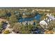 Aerial view of community with lake and homes at 3300 Haviland Ct # 303, Palm Harbor, FL 34684