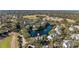 Aerial view of a lakefront community with lush landscaping, showcasing the property's location and surroundings at 3300 Haviland Ct # 303, Palm Harbor, FL 34684