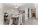 Bright dining area with a view of the kitchen and hardwood floors at 3300 Haviland Ct # 303, Palm Harbor, FL 34684