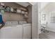 Convenient laundry closet with washer, dryer, and ample storage at 3300 Haviland Ct # 303, Palm Harbor, FL 34684