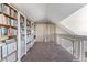 Spacious loft area with built-in bookcases, ideal for home office or library at 3300 Haviland Ct # 303, Palm Harbor, FL 34684