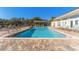 Inviting community pool with lounge chairs and a pergola at 3300 Haviland Ct # 303, Palm Harbor, FL 34684