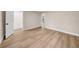 Empty bedroom with light walls and wood-look flooring, and closet at 3504 N 9Th St, Tampa, FL 33605