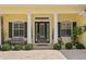 Inviting entryway with black front door, white columns, and lush greenery at 4023 W Horatio St, Tampa, FL 33609