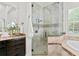Spa-like shower with glass enclosure and stone tile at 4023 W Horatio St, Tampa, FL 33609