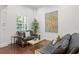 Elegant sitting area with two leather sofas, hardwood floors, and large artwork at 4023 W Horatio St, Tampa, FL 33609