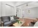 Elegant sitting area with a leather sofa and coffee table, overlooking the dining area at 4023 W Horatio St, Tampa, FL 33609
