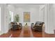Elegant sitting area with two leather sofas, hardwood floors, and large artwork at 4023 W Horatio St, Tampa, FL 33609
