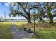 Landscaped backyard with stone bench and lamp post at 405 Chastain Rd, Seffner, FL 33584