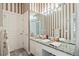 Bathroom with granite countertop and striped wallpaper at 405 Chastain Rd, Seffner, FL 33584