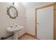 Small bathroom with pedestal sink and oval mirror at 405 Chastain Rd, Seffner, FL 33584