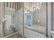 Double vanity bathroom with granite countertop and striped wallpaper at 405 Chastain Rd, Seffner, FL 33584