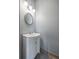 Small bathroom with white vanity and a round mirror at 405 Chastain Rd, Seffner, FL 33584