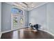 Bright bedroom with hardwood floors and French doors leading to a balcony at 405 Chastain Rd, Seffner, FL 33584