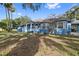 Side view of a charming blue house with mature trees at 405 Chastain Rd, Seffner, FL 33584