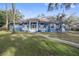 Stunning blue house with a large front yard and walkway at 405 Chastain Rd, Seffner, FL 33584