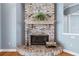 Brick fireplace with wood storage and wrought iron tools at 405 Chastain Rd, Seffner, FL 33584