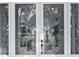 White front door with etched glass featuring bird and plant designs at 405 Chastain Rd, Seffner, FL 33584
