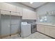 Laundry room with washer, dryer, and ample cabinet space at 405 Chastain Rd, Seffner, FL 33584