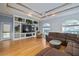 Spacious living room featuring hardwood floors, a large TV, and comfortable seating at 405 Chastain Rd, Seffner, FL 33584