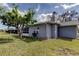Backyard view showcasing the home's exterior and landscaping at 4175 104 N Ave, Clearwater, FL 33762