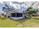 Spacious backyard with a screened patio and lush lawn at 4175 104 N Ave, Clearwater, FL 33762