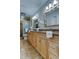 Bathroom with double sinks, wood cabinets, and a large shower at 4175 104 N Ave, Clearwater, FL 33762