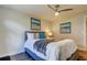 Serene bedroom with a gray platform bed, ocean-themed art, and ceiling fan at 4175 104 N Ave, Clearwater, FL 33762