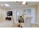Dining area features glass table, four chairs, and view to living room at 4175 104 N Ave, Clearwater, FL 33762