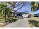 Cute bungalow with a spacious front yard, lush landscaping, and a large tree at 4175 104 N Ave, Clearwater, FL 33762