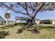Charming house with a tree-shaded front yard and well-manicured lawn at 4175 104 N Ave, Clearwater, FL 33762