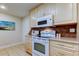 Kitchen features white appliances, light wood cabinets and tile backsplash at 4175 104 N Ave, Clearwater, FL 33762
